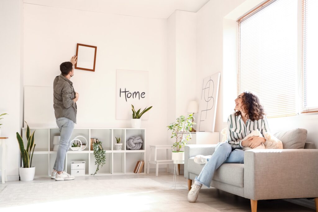 Young couple decorating rental property